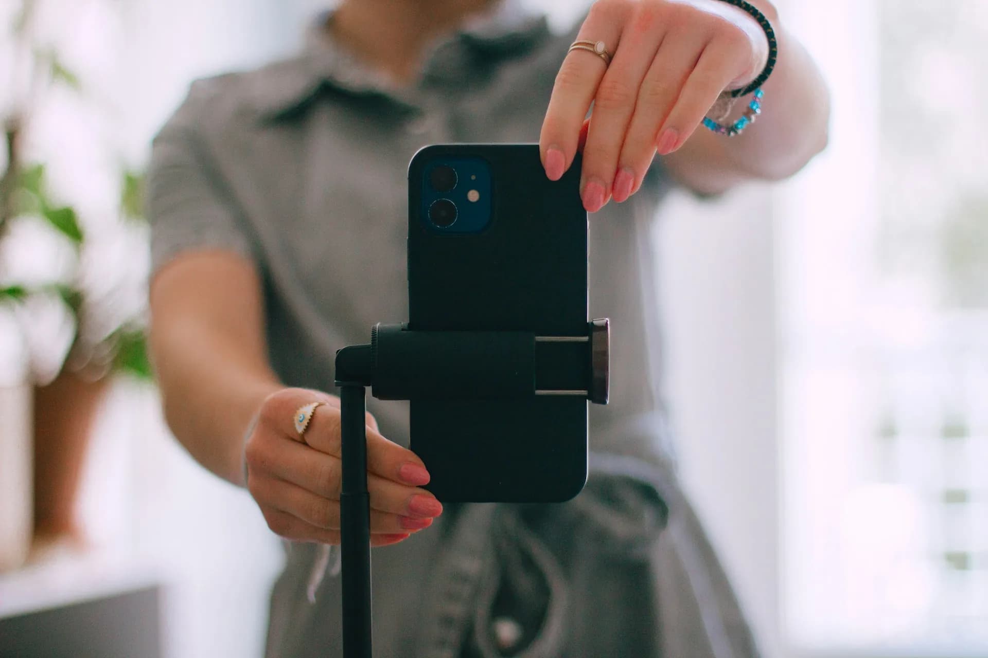 Person shooting vertical video on a smartphone for social media content.