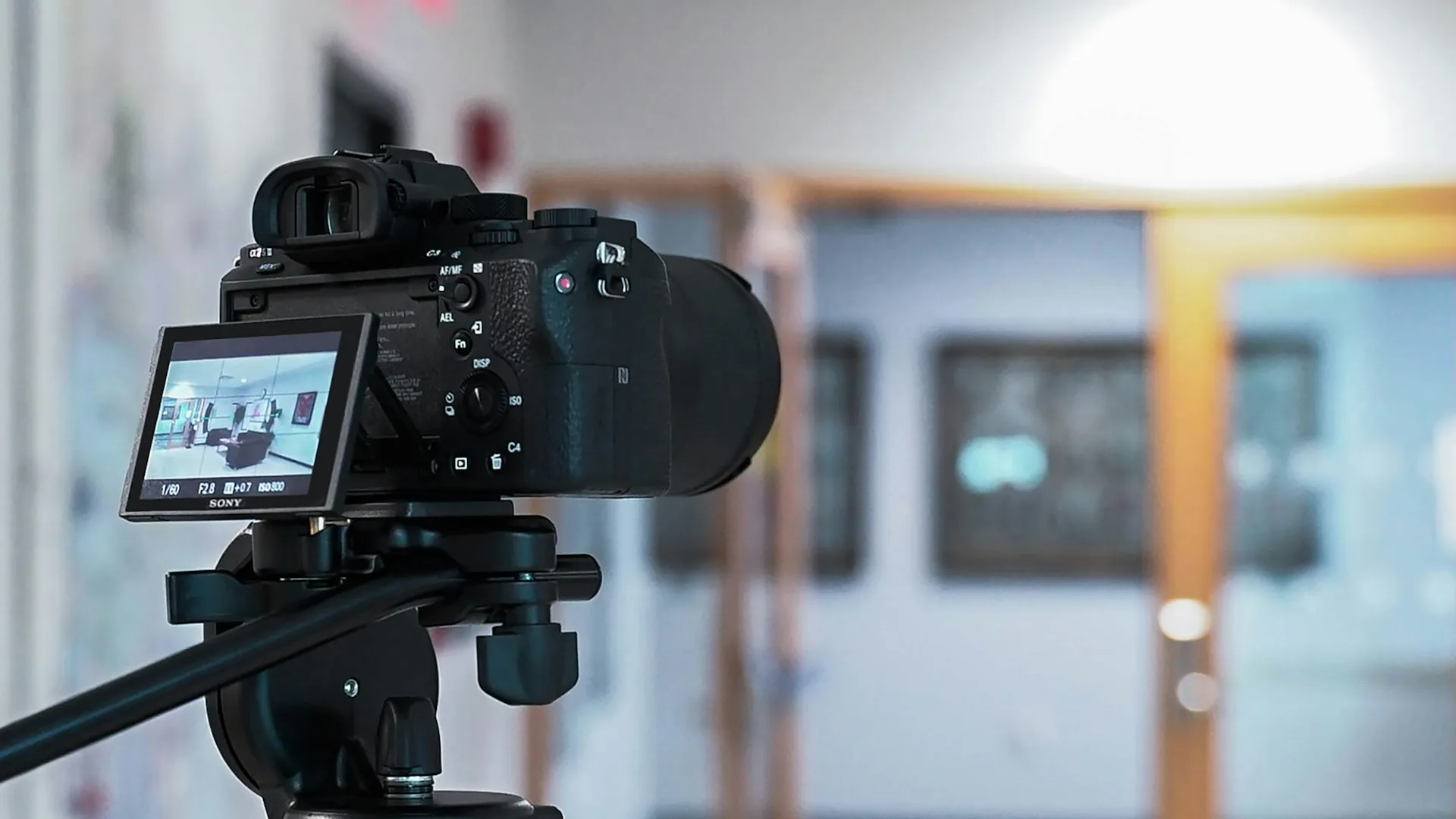 Camera on a tripod ready to film B-roll inside an office
