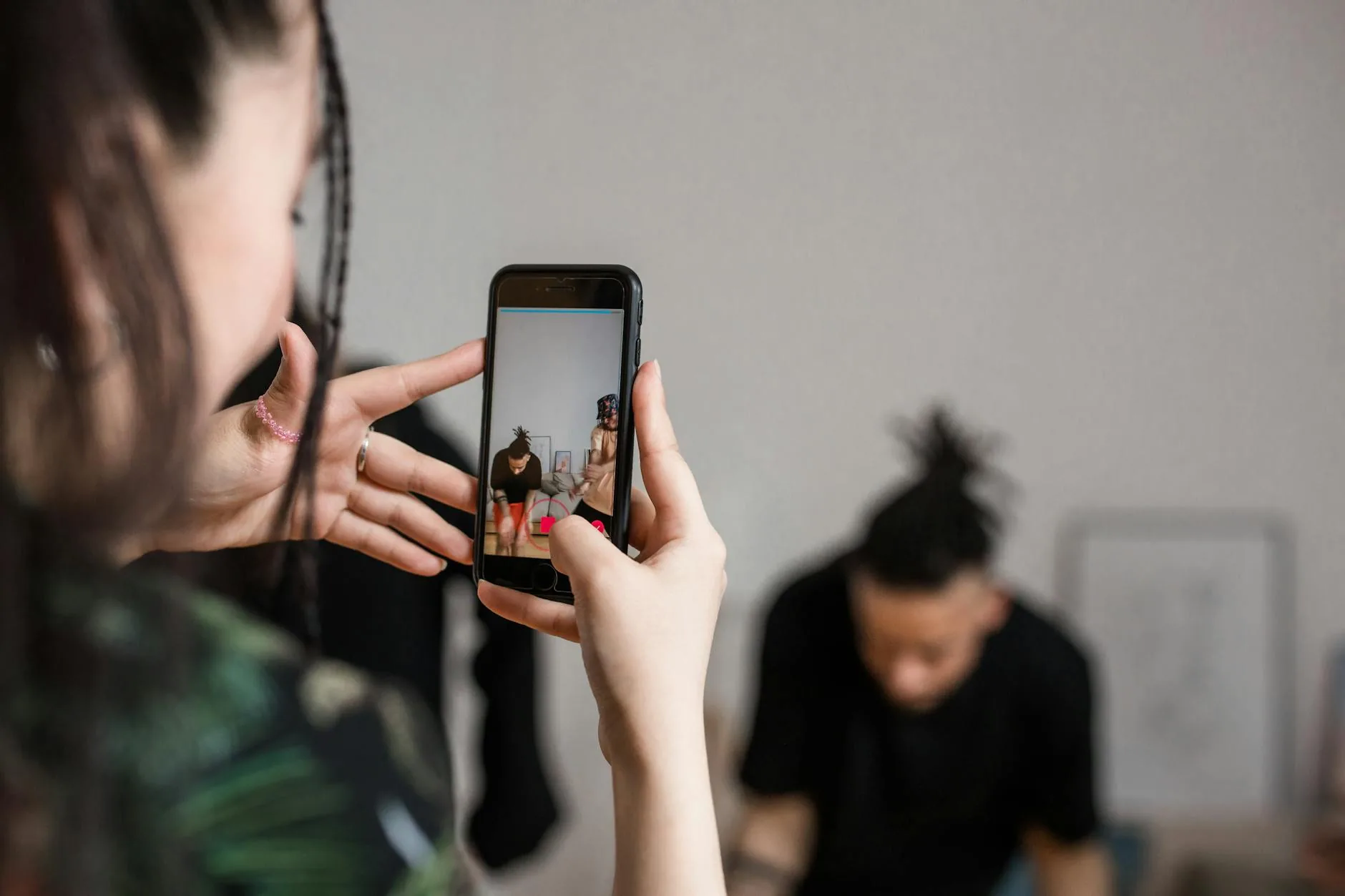 Person filming vertical content on a smartphone for social media