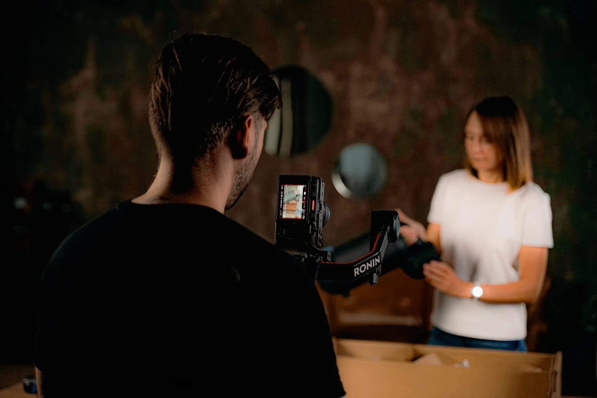 Filming a woman with a camera and gimbal rig.
