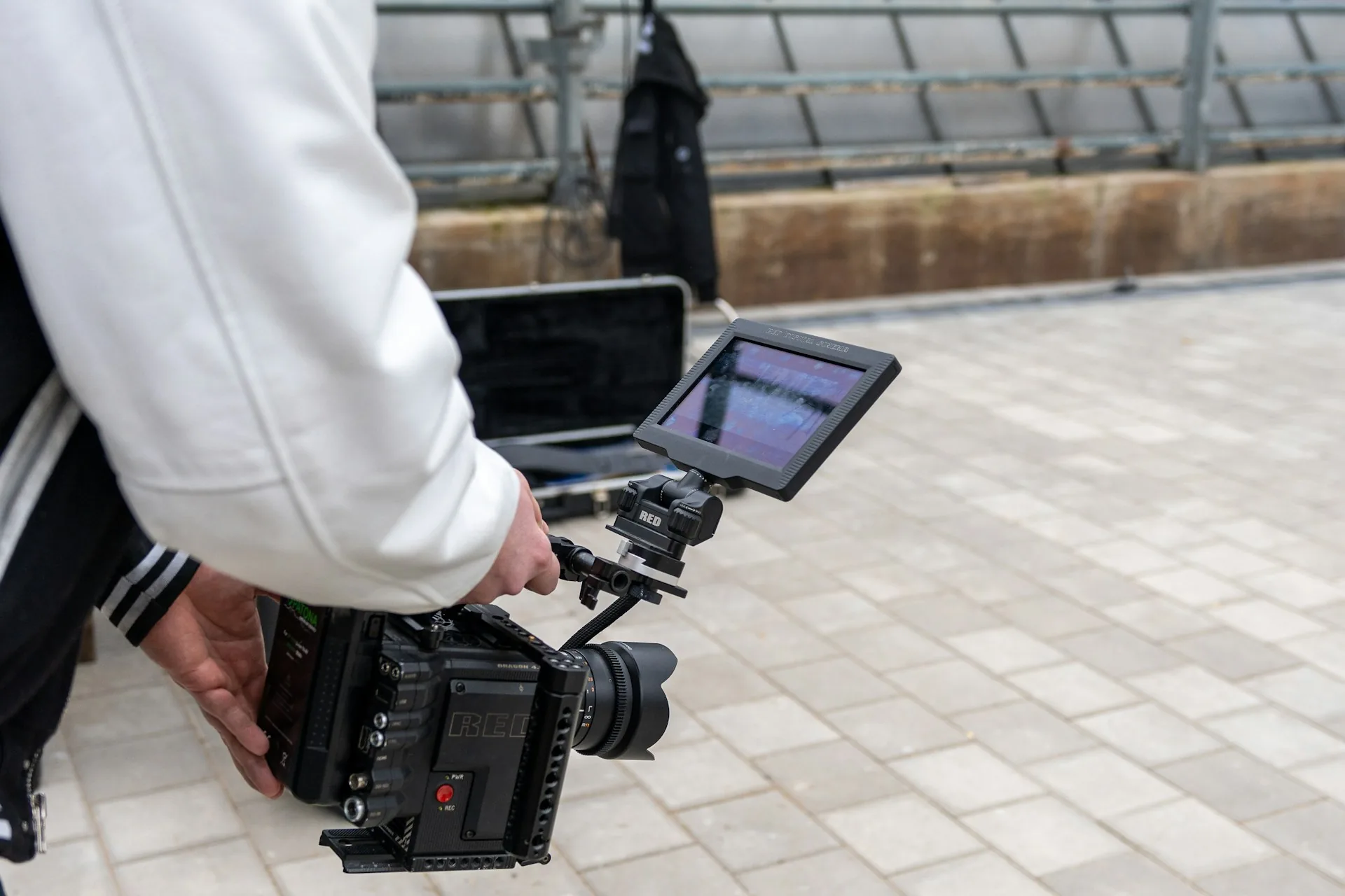 Filmmaker holding a camera before covering a corporate event