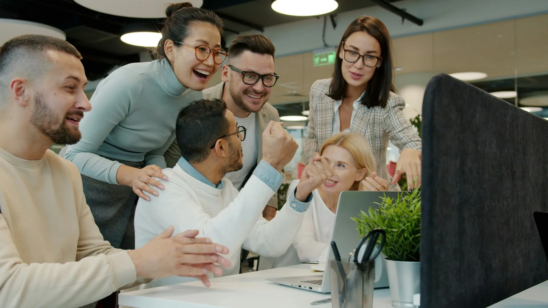 Coworkers celebrating an achievement together in the office