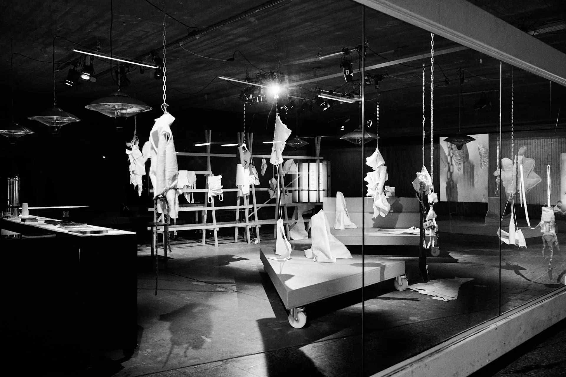Monochrome interior with hanging pieces and display platforms