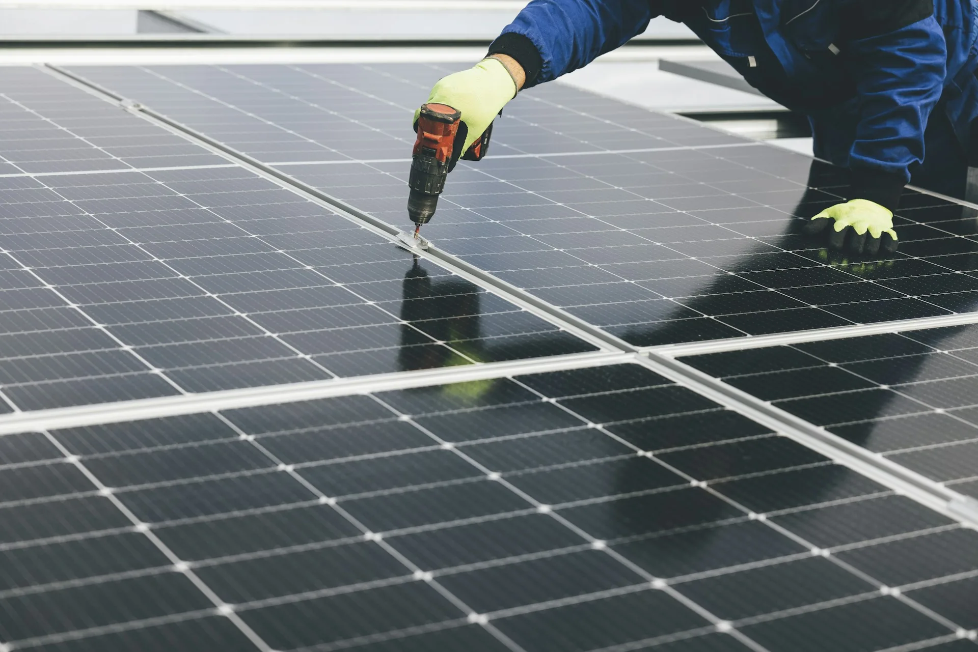 Technician installing and inspecting a solar panel