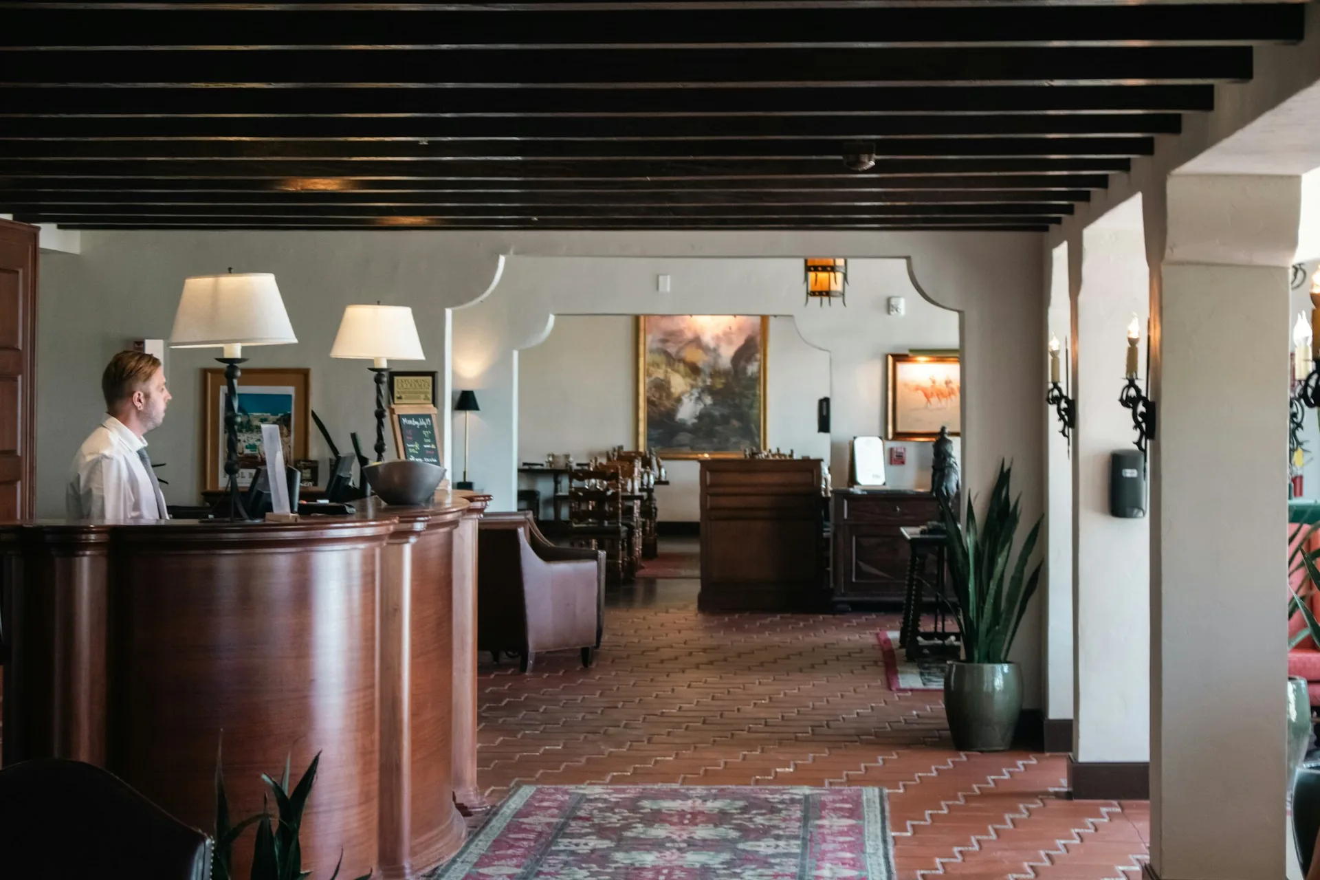 Recepción de un hotel boutique con mostrador de madera e iluminación cálida