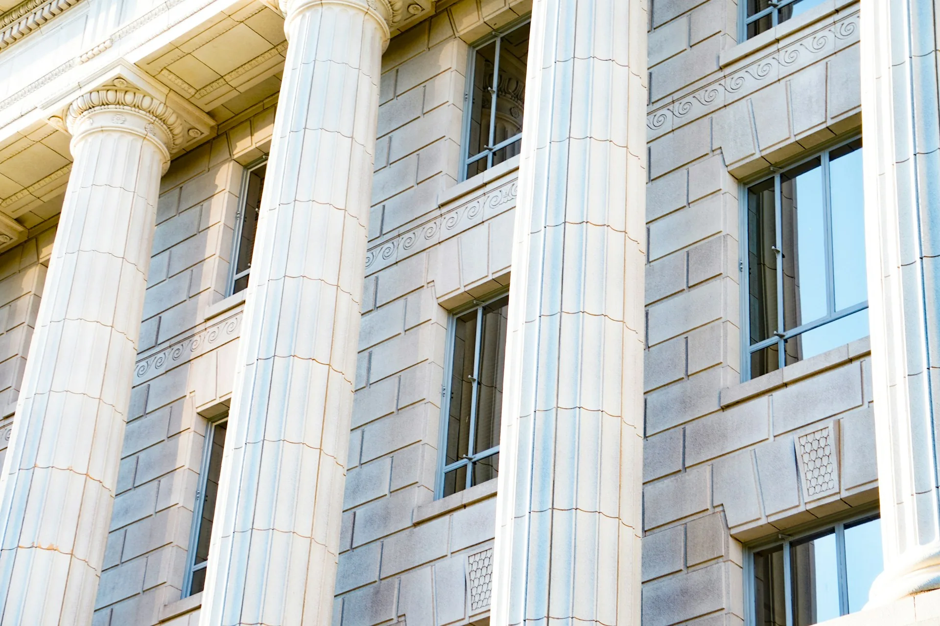 Facade of a white stone government building during the day