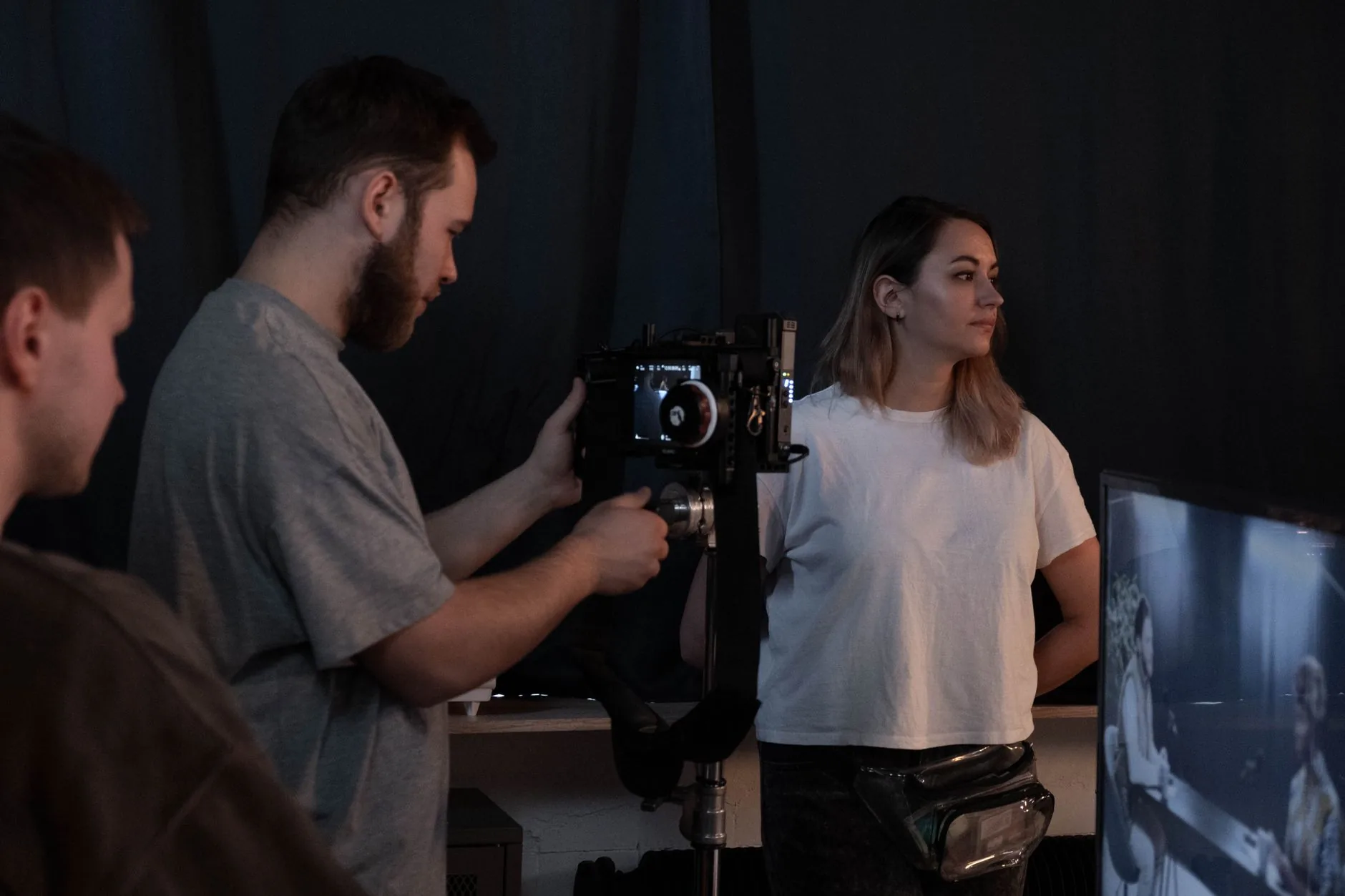 Production crew collaborating in a studio while filming a brand video with professional equipment