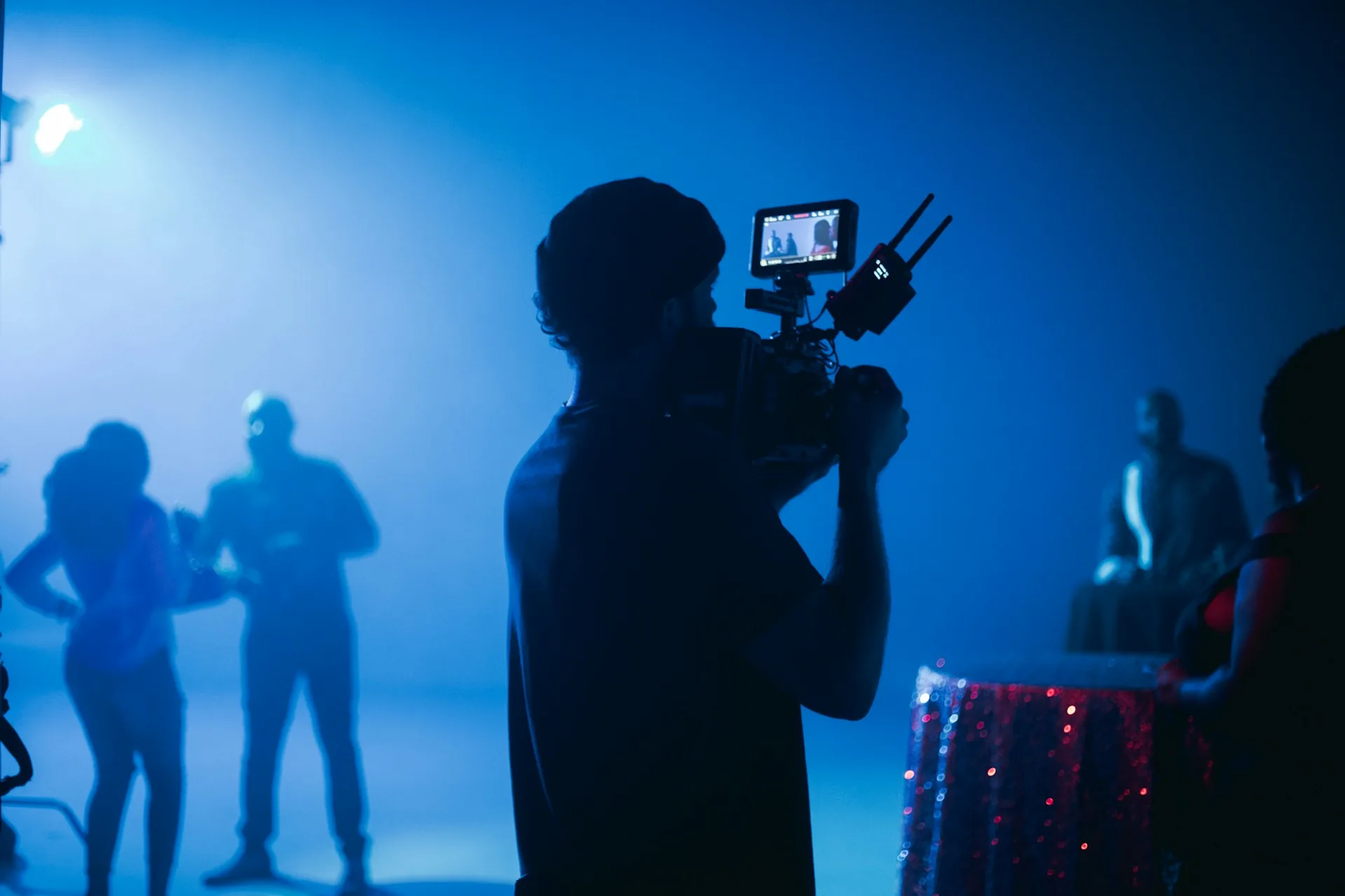 Handheld camera covering a corporate event in a conference room