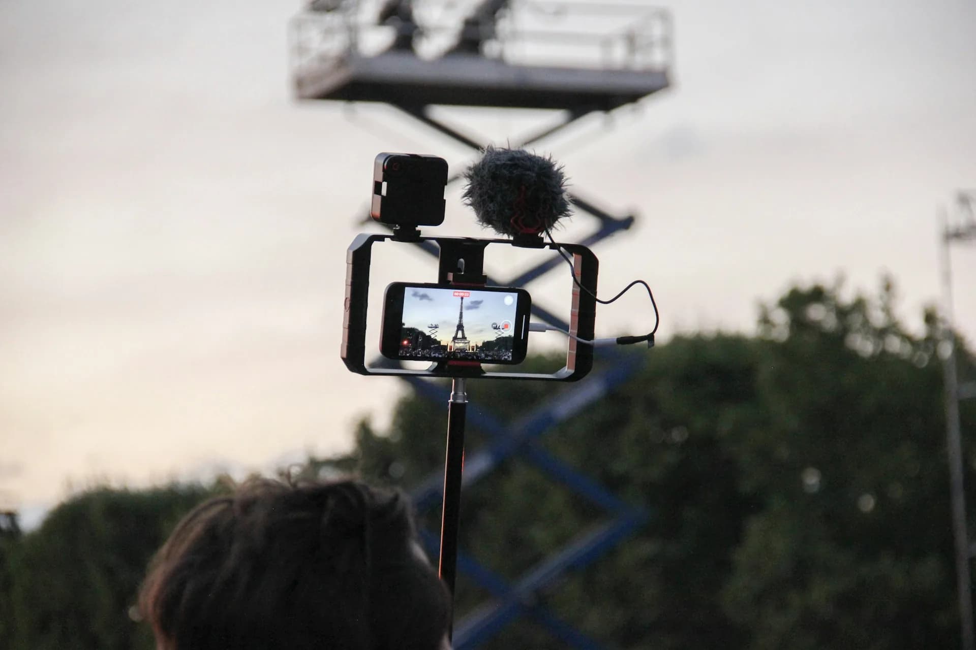 Person recording vertical video on a smartphone in 9:16 format