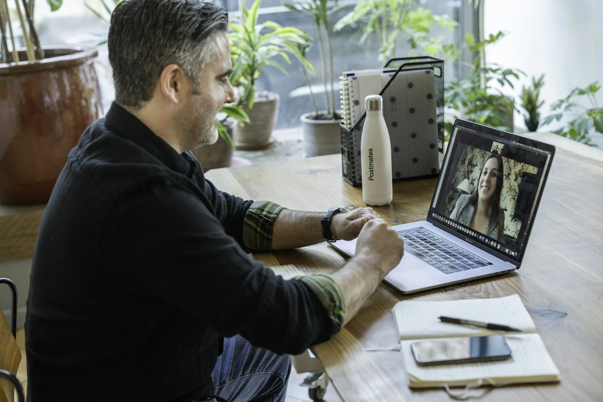 Person working on a laptop during a video call