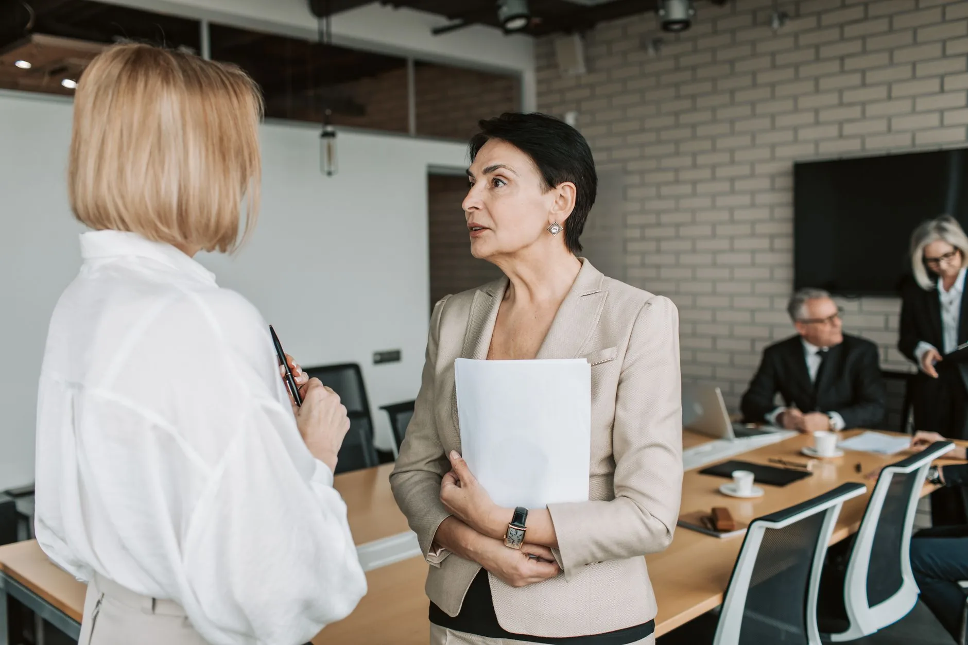 Two professionals talking during a business meeting in a modern office