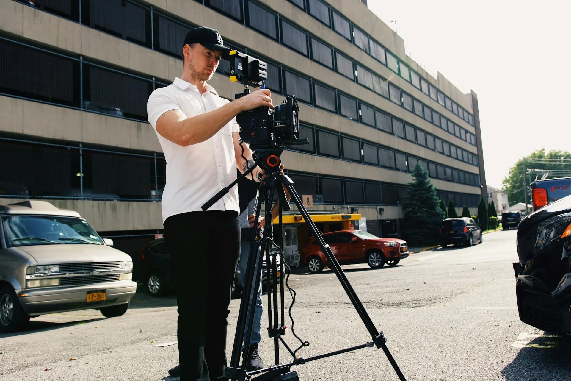 Camera operator filming a professional video for a company outdoors